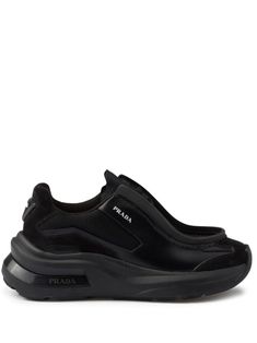 black leather panelled design mesh panelling logo print to the side round toe elasticated straps branded heel counter chunky rubber sole Prada Logo, Leather Fabric, Sneakers Black, Logo Print, Womens Shoes Sneakers, Calf Leather, Rubber Sole, Prada, Shoes Sneakers