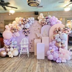 balloons are arranged in the shape of letters and flowers for a baby's first birthday party