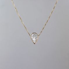 "One of my very first designs, and still remains one of my relished pieces. Featuring a beautiful pear shaped diamond necklace, hand wrapped in 14k gold to preserve the delicate simplicity of this diamond. ---------------D E T A I L S--------------- - .70 ct pear shaped diamond, G SI+ - Wrapped in 14k gold wire - 14k gold cable chain with a lobster clasp closure, 0.5 mm - Available in 14k white, yellow or rose gold - Sizes 15 - 20 inches Available in 14k yellow white or rose gold, sizes 16 -18\" Best Jewelry Cleaner, Pear Shaped Diamond Necklace, Gold Necklace Layered, Layering Necklace, Pear Diamond, Pear Shaped Diamond, Gold Wire, Cable Chain, Pear Shaped