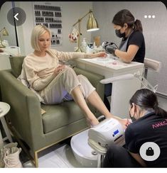 two women in a salon getting their feet examined by a professional hair stylist