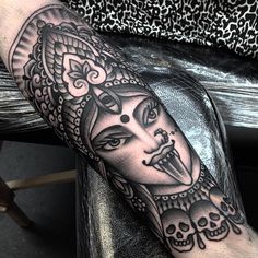 a man's arm with a mask on it and skulls around the wrist,