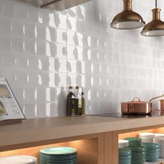 a kitchen counter with plates and bowls on it