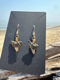 the earrings are on display by the beach