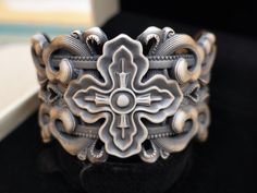 This is one of The Most beautiful cuff we have made indeed, a truly Stunning master piece composed of 105 grams of fine silver, with this marvelous Hollow out engraving of Tibetan lucky knot ( also called Endless Knot or Eternal Knot ) and Tibetan meditation Vajra .  Vajra is often used for protection from negativities and weak mind,  it is a symbolic ritual tool that is used in Buddhism, Hinduism, and Jainism to represent the unyielding power of spirit. It is a Sanskrit word that means 'thunder Spiritual Silver Cuff Bracelet With Intricate Design, Handmade Custom Silver Bracelets, Custom Silver Handmade Bracelets, Eternal Knot, Tibetan Meditation, Endless Knot, Meditation Bracelet, Ritual Tools, Wide Cuff Bracelets