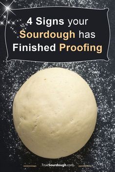 a round ball of dough sitting on top of a black surface with the words 4 signs your sourdough has finished proofing