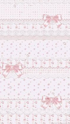 a pink and white wallpaper with bows on the top, and lace around the edges