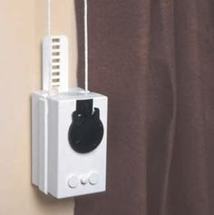 an electrical device hanging from the side of a curtain