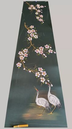 two birds are standing next to each other on a black background with white and pink flowers