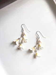 Three little white flowers hanging on a branch in silver color. Cultured freshwater pearls were added on the branch. A pair of cute and elegant image earrings. More about her: Resin: Japanese resin in white and yellow color. Wire for flowers: 0.45mm silver plated brass wire  Branches: 1.02mm sterling silver filled brass wire. Closure: 925 sterling silver fishhook ear wire/Brass ear clip in silver color  Pearls: 8mm cultured freshwater pearls in white color. Care: To enlarge the life of our jewelry please do not press, do not crush, do not pull the pair and store it in the bag provided. Little White Flowers, Flowers And Pearls, Flowers Hanging, Pearls Earrings, Color Care, Freshwater Cultured Pearls, Ear Wire, Chandelier Earrings, Yellow Color