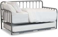 a metal daybed with white sheets and pillows on it's side, against a white background