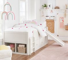 a child's bedroom with white furniture and pink rugs on the hardwood floor