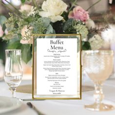 a table setting with menus and wine glasses