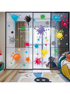 a child's bedroom with colorful decorations on the glass doors