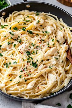 pasta with chicken and parsley in a skillet