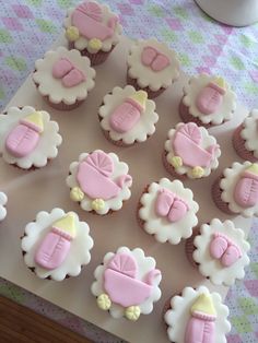 cupcakes decorated with pink and white icing on a table