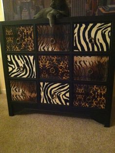 an animal print dresser with several drawers