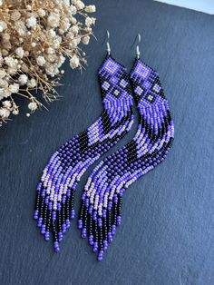 These long earrings made of lilac beads with black inserts and fringe represent a unique blend of style and sophistication. The delicate lilac shade adds a touch of romance to the accessories. The design is completed with fringe, creating lightness and movement, making the earrings especially appealing. Made from Czech beads. Hypoallergenic clasp. Length 6.9 inches (17.5cm). Width 0.8 inches (2cm). If you want these earrings in a different color, write to me and I will be happy to make them for Earrings Chandelier, Long Fringe, Earrings Purple, Long Fringes, Purple Earrings, Earrings Long, Earrings Statement, Earrings Boho, Czech Beads