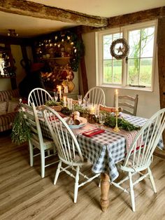 a dining room table is set with place settings and candles for the dinner guests to enjoy