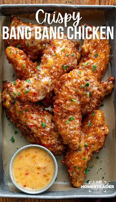 crispy bang bang chicken in a pan with dipping sauce