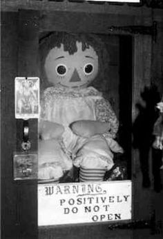 an old creepy doll is on display in front of a sign that says, the real ananabella cell from'the corinno