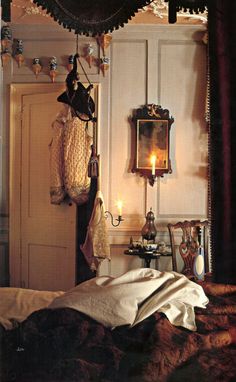 an old fashioned bedroom with antique furniture and candles