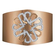 This edgy cuff bracelet is designed in a high polished 18 karat rose gold. The center motif is a triple layered "X" that forms a flower. Two of the layers are 18 karat white gold set with round brilliant diamonds. The cuff bracelet is approximately 2" at the widest , with a slight taper. The inside diameter is 2.25" . The bracelet is designed with an invisible hinge in the back portion, allowing it to be put on and off easily. This cuff bracelet is part of the collection made for Cellini NYC. Pl Collectible Cuff Bangle With Intricate Design, Luxury Antique Cuff Bracelet With Intricate Design, Luxury 14k Rose Gold Cuff Bracelet, Luxury Rose Gold Diamond Cuff Bracelet, Luxury Rose Gold Diamond-cut Bangle, Invisible Hinges, Wide Cuff Bracelets, White Gold Set, Wide Cuff