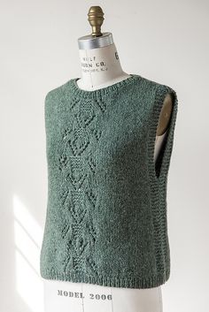 a green knitted sweater on a mannequin