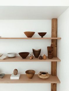 shelves with bowls and vases on them