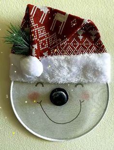 a white plate topped with a santa hat on top of a table next to a wall