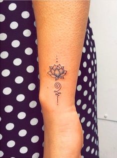 a woman's arm with a tattoo on it and a flower in the middle