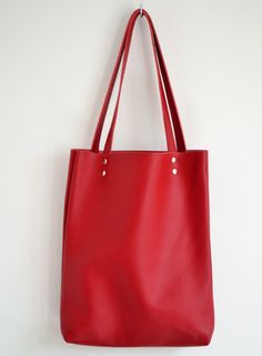 "SIMPLE LEATHER TOTE BAG Please click + More at the end of the description to see more details. Dimensions: Height: 15.5'' 39 cm Width: 12.2'' 31 cm Handles: 23.6'' 60 cm Handle drop: 10.2\" 26 cm Casual and simple tote bag made from high quality pebbled leather. It is slim, lightweight, strong and fits comfortably over the shoulder. * Highest quality Italian leather * Includes interior zipped pocket and key chain * Zipper & Hardware (Luxury gold or silver) * Fits a laptop (up to 13 inch) * Red Tote Bag With Leather Handles, Red Tote Shopping Bag, Red Tote Bag For Shopping, Red Leather Tote Satchel, Large Capacity Red Tote Bag, Red Large Capacity Tote Bag, Red Satchel With Leather Handles For Shopping, Modern Red Shoulder Bag With Leather Handles, Everyday Red Soft Leather Shoulder Bag