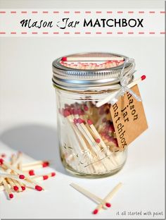 a glass jar filled with matches on top of a table