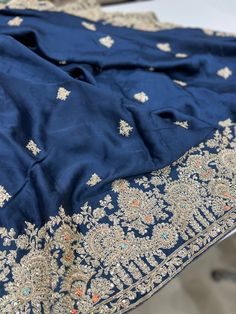 Rise and Shine. A beautiful Pure Satin Silk saree is heavily embellished with hand done Zardozi work. It's a saree which will stand out and it's a must have in your wardrobe this wedding season. Blue satin with Zardosi work make it a very special piece. This saree can be worn for your reception, sangeet or cocktail night and it sure will stand out. Silk Unstitched Suit For Reception And Navratri, Unstitched Jamawar Suit With Resham Embroidery For Reception, Diwali Reception Unstitched Suit With Cutdana, Eid Reception Unstitched Cutdana Suit, Eid Reception Cutdana Unstitched Suit, Banarasi Silk Salwar Kameez With Resham Embroidery For Reception, Silk Saree With Dupatta For Reception, Jamawar Unstitched Suit With Intricate Embroidery For Reception, Unstitched Jamawar Suit With Intricate Embroidery For Reception