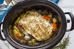 a pot filled with chicken and vegetables on top of a table