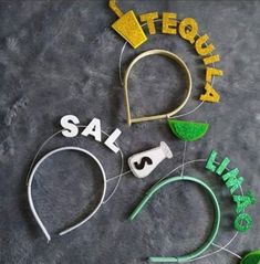 the word sale spelled out with green and yellow letters on a gray surface next to scissors