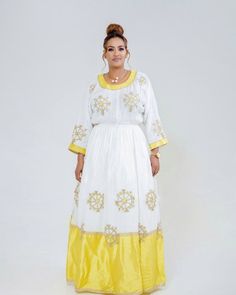 This Habesha Kemis is a true embodiment of chic and sophistication, with a beautiful Menen fabric, Shimena bottom, and Tilf dress. The Menen fabric provides a soft and luxurious texture that drapes beautifully over the body, creating an elegant and effortless fit. The Shimena bottom of the dress adds a touch of traditional Ethiopian design, with intricate patterns and vibrant colors that catch the eye. The Tilf design on the dress adds a touch of modernity and simplicity, with sleek and minimali Eritrean Dress, Ethiopian Wedding, Habesha Dress, Habesha Kemis, Gala Events, Traditional Clothes, Clothes Shop, Intricate Patterns, Traditional Outfits