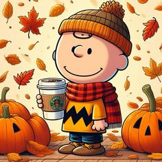 a charlie brown holding a cup of coffee in front of some pumpkins and leaves