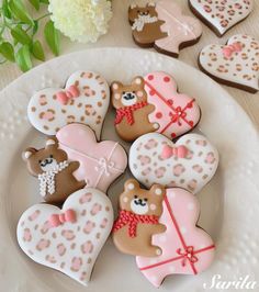 decorated cookies are arranged on a white plate