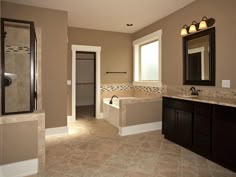 a large bathroom with two sinks and a bathtub