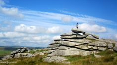 a person standing on top of a rock formation