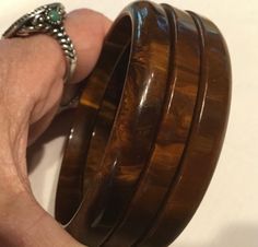 This is a vintage 1940s-1950s, original & complete, matched, 3 piece, "Bookend" set of brown, marbled, bakelite bangles.  They have been Simichrome tested with positive, bakelite results.  Are they "Mississippi Mud" you ask?  I do not know, am not an authority.  These chocolate, brown, bangles have a mottled pattern consisting of various shades of brown & golden butterscotch.  They are narrow, original, matching set of bangles each one slightly different in size with a diameter of 2.5 inches.  T Brown Bangles, Mississippi Mud, Bakelite Bangles, Brown Jewelry, Bangle Bracelet Set, Crystal Bangle, Jewelry Fashion Trends, Shades Of Brown, Jewelry Lookbook