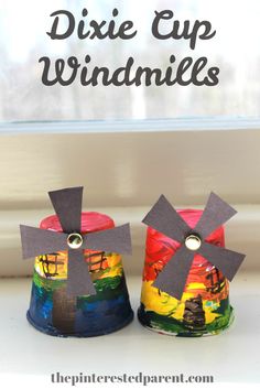 two paper cup windmills sitting on top of a window sill with the words dixie cup windmills