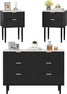 three black and white sideboards with gold handles, one has a vase on top