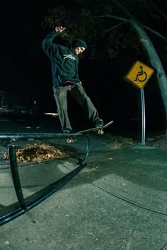 a man riding a skateboard down the side of a metal rail