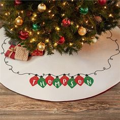 a christmas tree skirt with ornaments on it