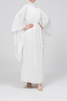 The Eternal Ivory Satin Kimono Sleeve Nikah Maxi Dress is designed for those cherished moments of love and celebration. Crafted from luxurious satin, this dress features a timeless, clean-cut front and gracefully draped extra-long kimono sleeves, offering both elegance and modesty. The detachable belt cinches the waist, creating a flattering silhouette, while the dress's comfortable lining ensures ease of wear. Perfect for special occasions like Nikah or bridal events, this sophisticated maxi dr Wedding Maxi Dress With Satin Finish, Elegant White Satin Maxi Dress, Elegant White Satin Dress For Formal Occasions, White Maxi-length Wedding Gown, White Maxi Wedding Gown, White Silk Satin Dress For Formal Occasions, White Maxi Length Wedding Gown, Elegant White Satin Silk Dress, White Maxi Length Wedding Dress For Wedding Night