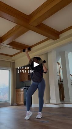 a woman is doing exercises in the living room