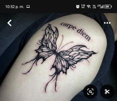 a black and white butterfly tattoo on the arm