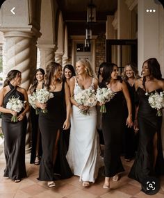 a group of women standing next to each other holding bouquets in their hands and posing for the camera