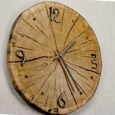 a clock made out of wood with numbers on the face and hands that are connected to each other